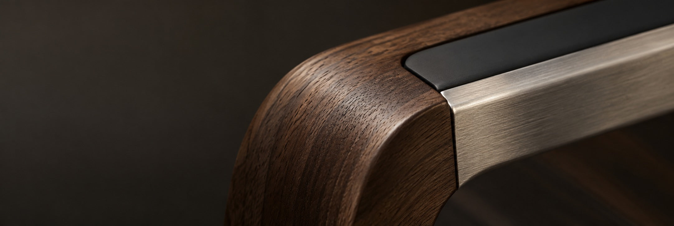 Close-up of walnut, brushed aluminium and silicone